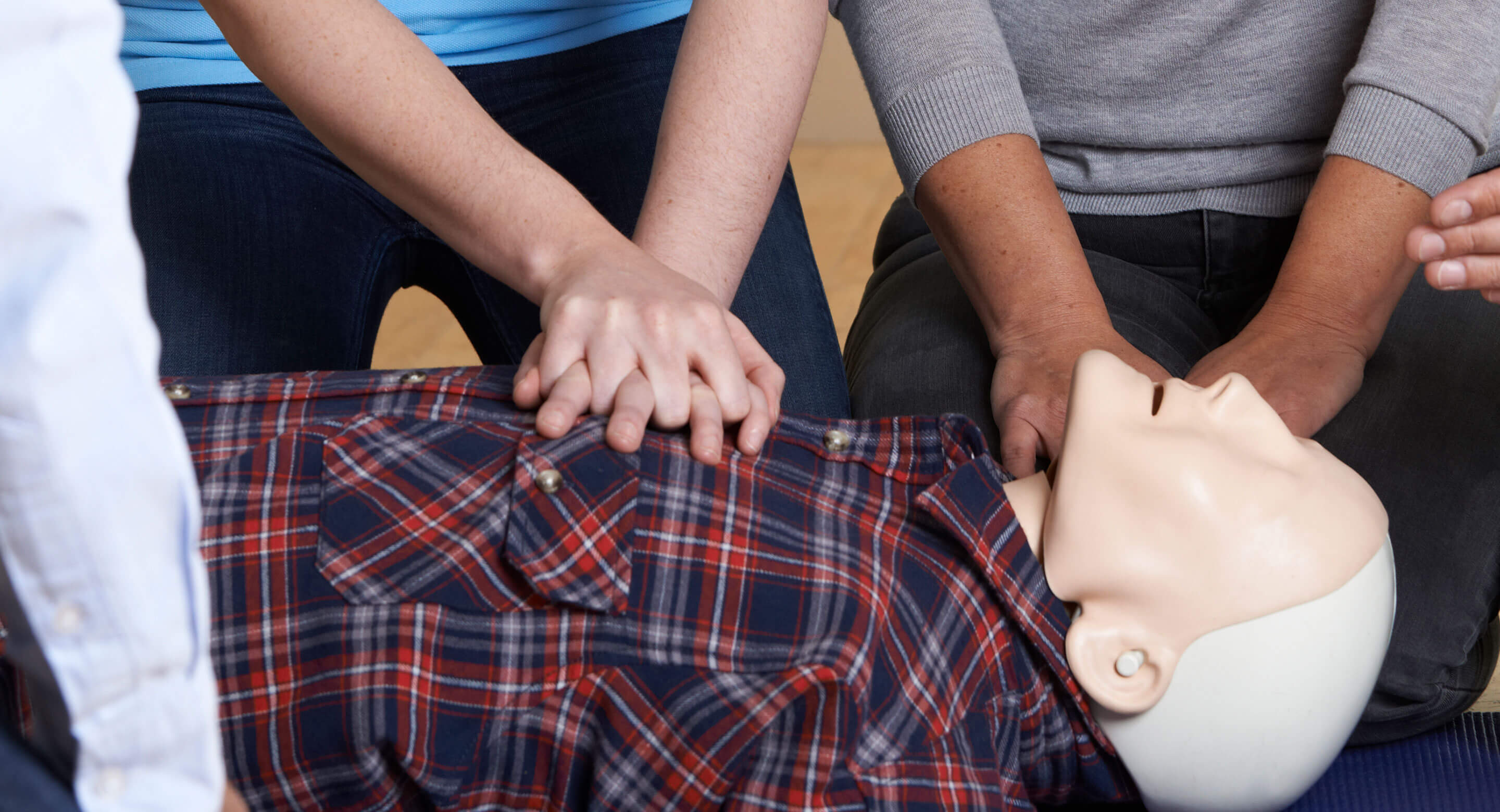 Team CPR training on simulation dummy.