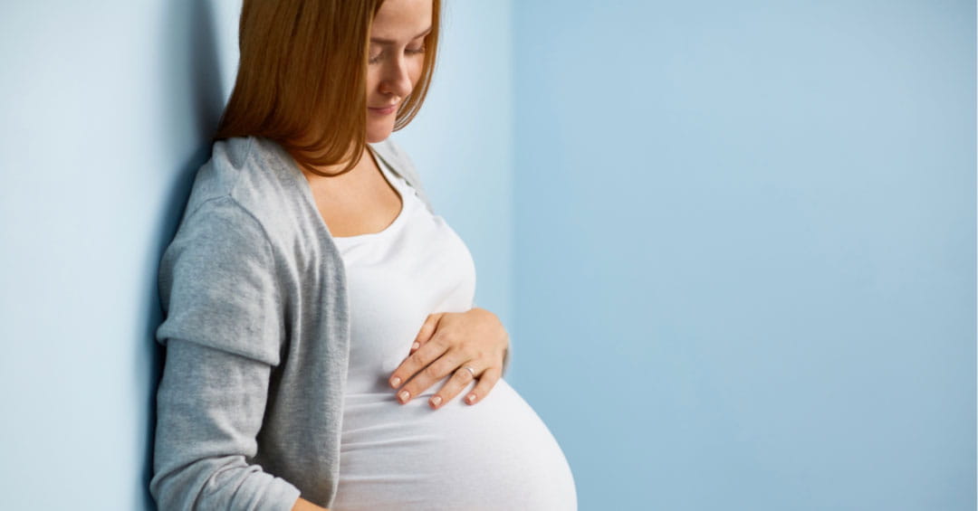 Image of a pregnant woman holding her belly